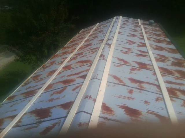 Rusted metal roof panels with new wood purlins before replacement — Storm Damage Roof Repair in Delaware by Roofing Brothers